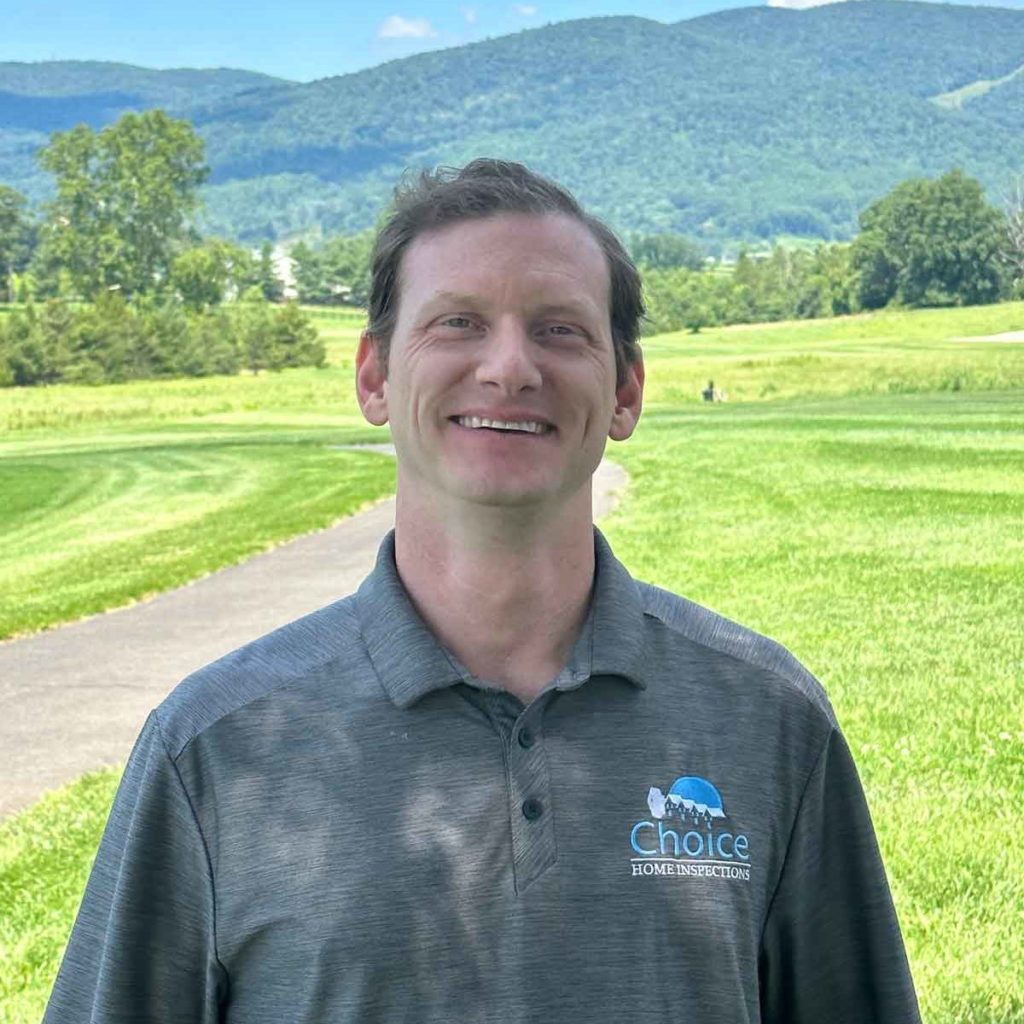 Hunter Rayfield, home inspector in Virginia standing in front of grass and moutains